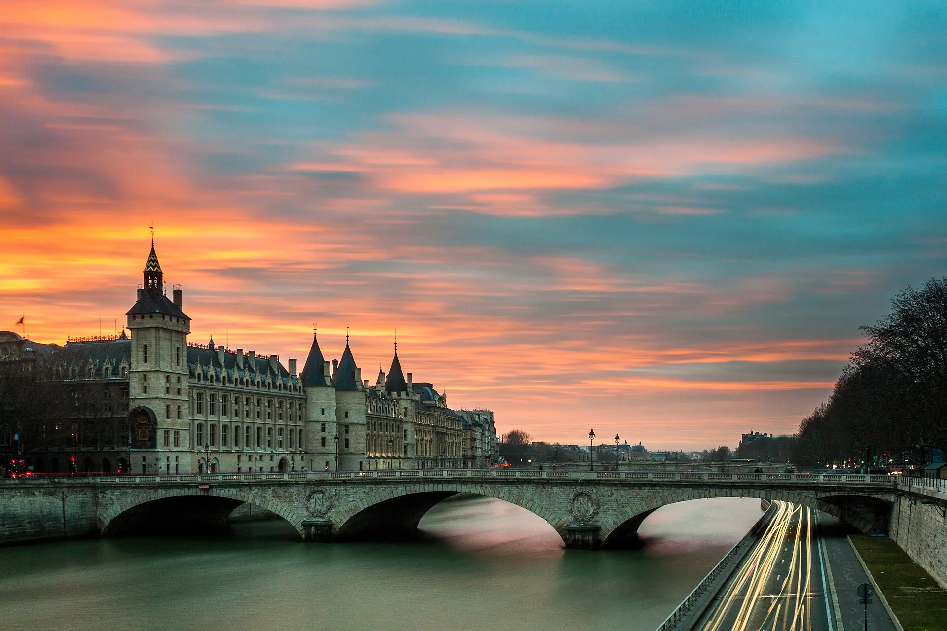 The Seine at sunset with a Paris bridge in silhouette